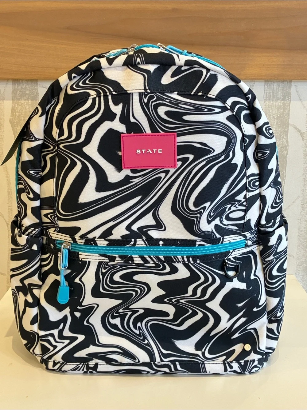 STATE Black & White Swirl Backpack with Pink Logo and Teal Accents